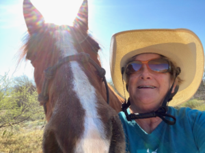 Selfie of Elaine Powers with her horse Button