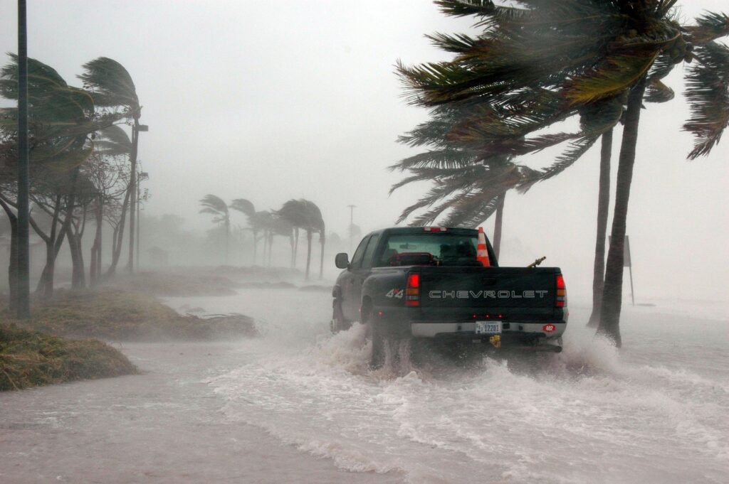photo of truck driving through hurricane