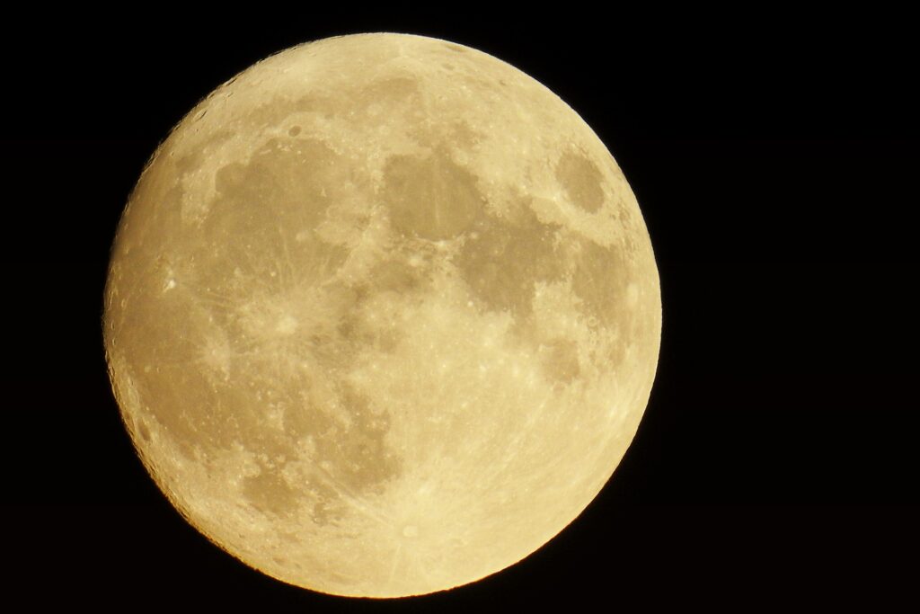 image of a light gold full moon