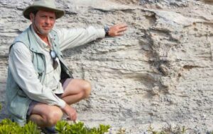 Anthony Martin next to the trace fossil of the Pleistocene iguana burrow. Credit Melissa Hage.