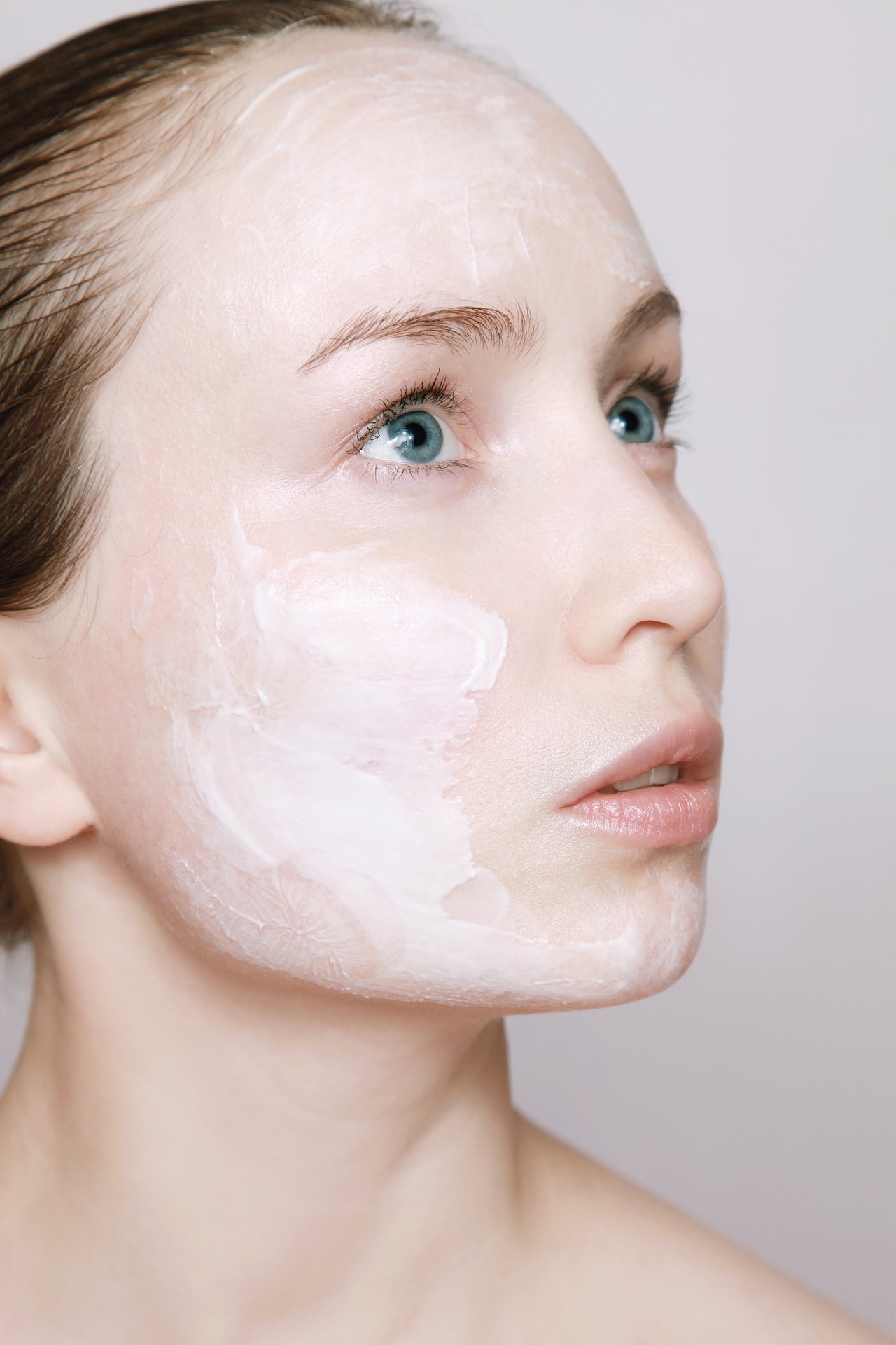 image of young woman's face with lotion