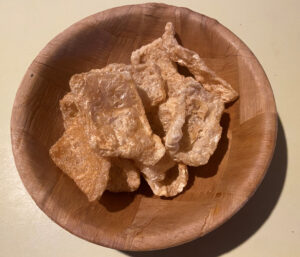 A bowl of the microwaved pork rinds, their appearance is exactly like bagged pork rinds.