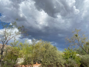 Gray clouds converging over the desert.