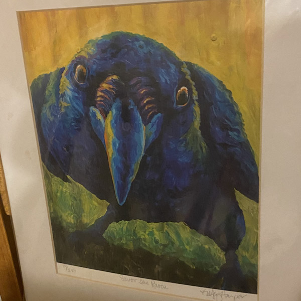 A framed painting of a raven.