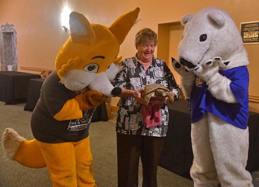 Zoe meeting the Fox Theatre and Bear Essential News mascots.
