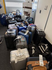 Luggage piled up at an airport gate.